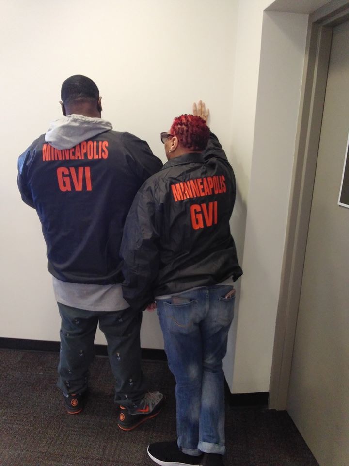 Two Minneapolis Group Violence Intervention outreach workers wearing GVI jackets