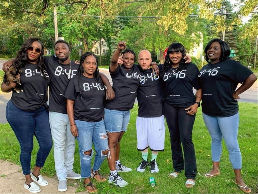 Seven The Urban Conservation community members wearing black 8:46 shirts during social-justice outreach